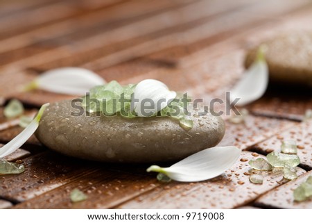 Green bath salt on brown spa stones