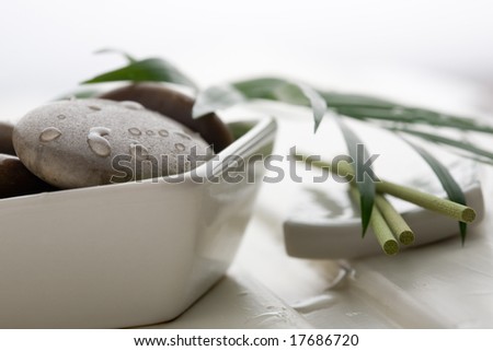 Brown massage stones in white bowl
