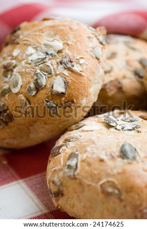 Fresh bread rolls on red table cloth