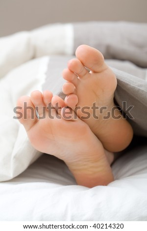 Teenager sleeping, toes showing under the sheet