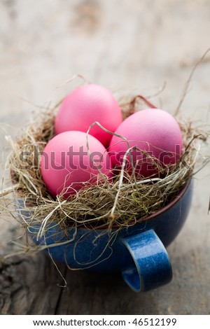 Pink easter eggs in blue coffee cup