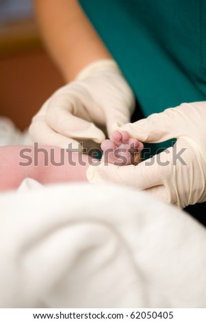 Newborn baby girl right after delivery, shallow focus
