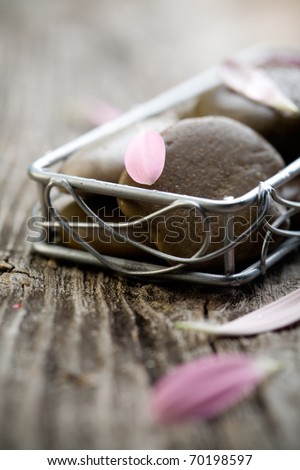Brown stones with water drops and flower petals