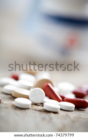 Collection of medicine pills on table, selective focus