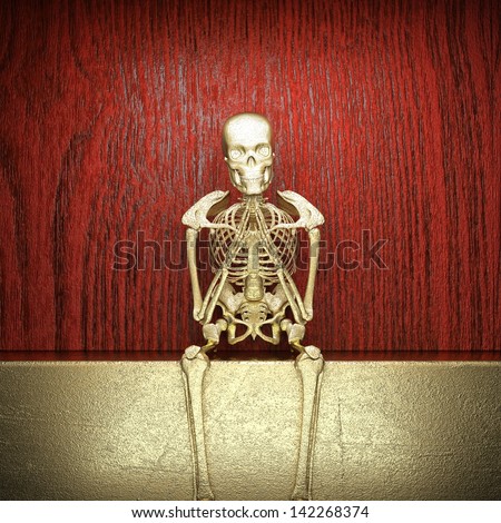 Golden skeleton on wood