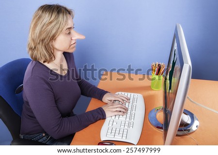 Woman with long nose sitting in his office, typing on the computer with the broken screen.  Liar concept. Human face expressions, emotions, feelings.