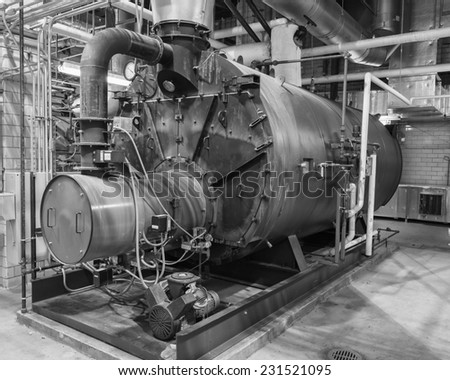 Industrial gas fired boiler.  Typical installation with piping, valves, breeching, and air compressor.