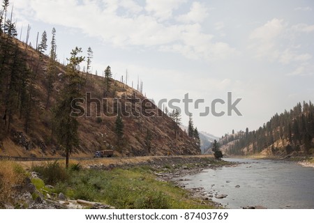 Clearwater river downstream of Kamiah.  Taken from Long Camp, where Lewis and Clark expedition stayed. Logging truck traveling on the road.