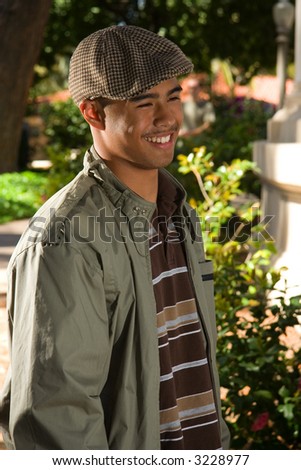 Ethnic mix teen male standing outside smiling