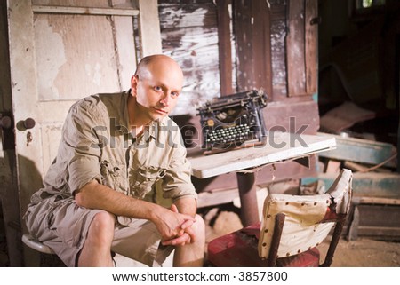 Man sitting next to Vintage typewriter