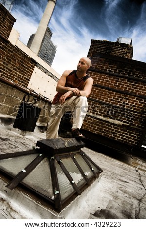 Cool guy on city roof smoking