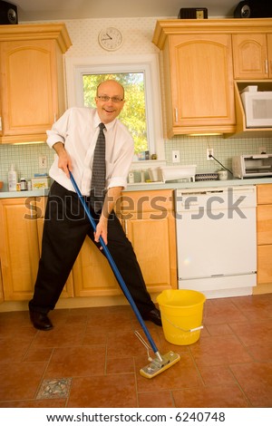 Businessman mopping kitchen floor