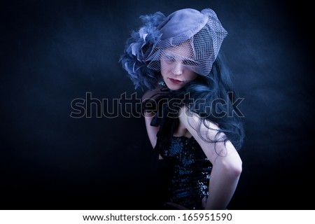 cold fashionable young widow - woman with feathered hat