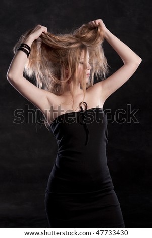 young woman with long hair - hair in hands above head, eyes closed