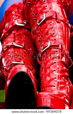 stock photo red latex fetish kinky boots with some metal buckles