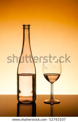 bottle and a broken wine glass - filled to the same level