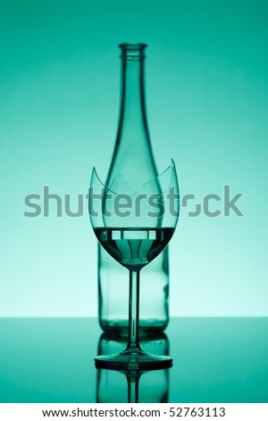 broken glass - in focus, and a bottle - out of focus