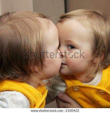 child playing with mirror