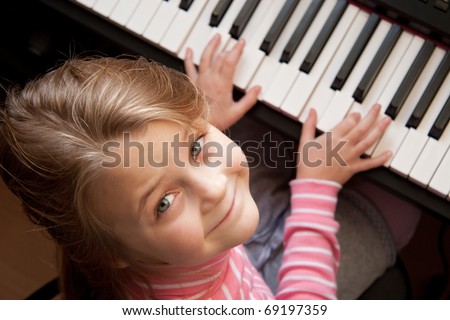 Young girl sitiing at digital piano Young girl sitiing at digital piano