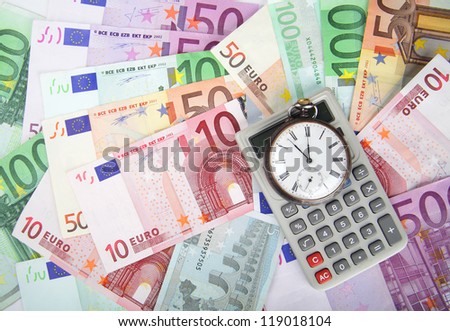 Time and Money concept image.  Close-up of euros and vintage watch and calculator.