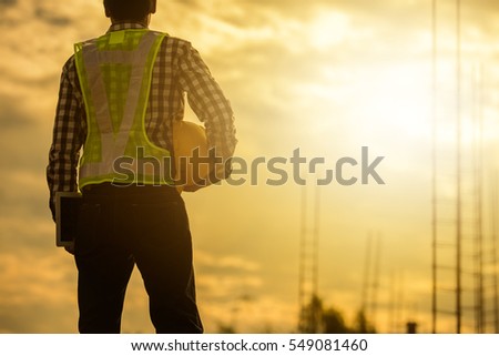 Engineer or Safety officer holding hard hat  in construction site.