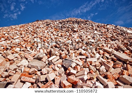 Big pile of different bricks in demolition waste recycling site