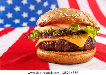 Juicy grilled hamburger on USA flag background