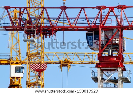 Construction site crane jibs and cabins closeup