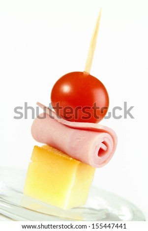 Cocktail stick snack with cherry tomato , smoke cheese and cold cuts roll