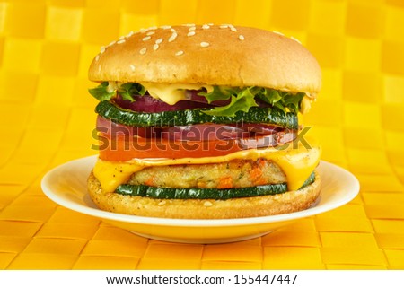 Vegetarian burger on plate , yellow background