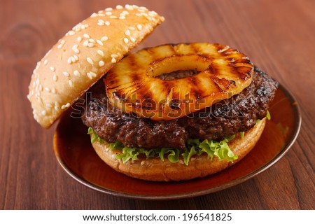 Burger with grilled pineapple on dish