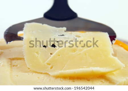 Closeup of cheese with slicer , shallow dof