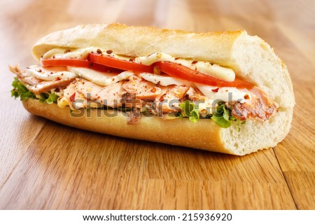Hot smoked salmon sandwich with tomato , mozzarella cheese , lettuce and mayonnaise