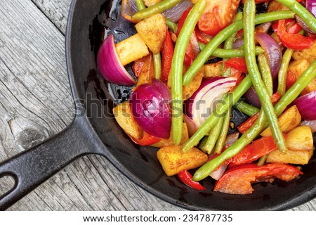 Mix of fried vegetables on frying pan , upper view