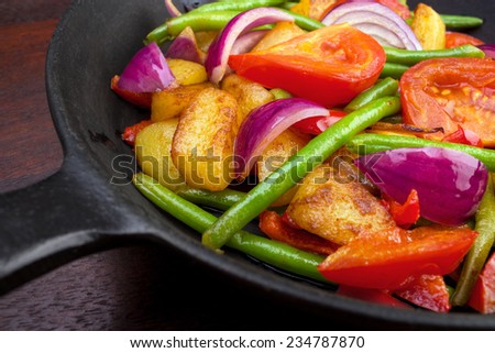 Cooked vegetables on frying pan closeup