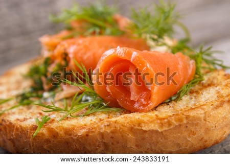 Salmon rolls with dill on toasted bread , shallow dof