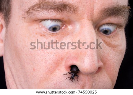 Scared man with the bug coming from his nose.