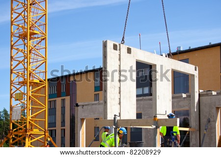 Construction site crane is used to placing precast concrete panels