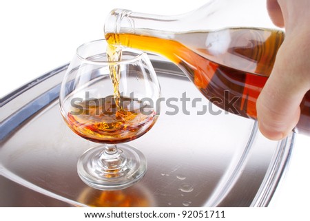 Pouring cognac into the sniffer on the serving tray