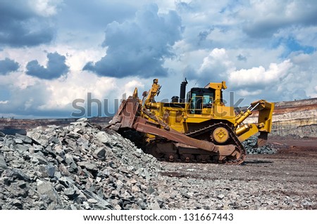 A picture of a big yellow bulldozer at work-site