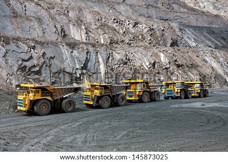 A picture of a big yellow mining trucks at work site