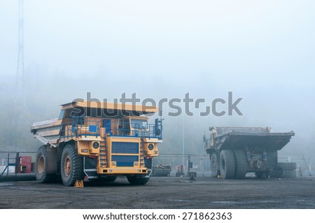 big yellow trucks at technical services area in fog