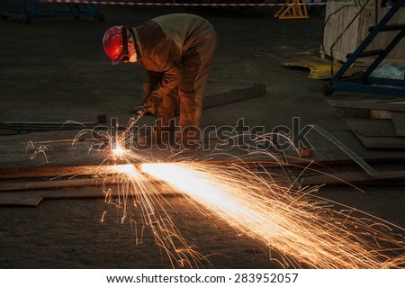 welder cut steel sheet at repair shop