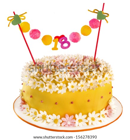 Birthday cake celebrating eighteen years, covering of flowers and daisies. Anniversary or birthday