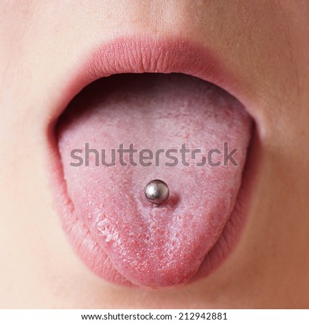 close-up of a female mouth with tongue piercing