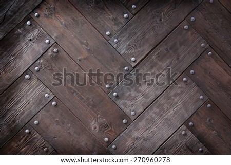 background made of weathered old wood timber planks with rivets