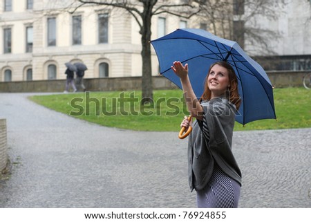 happy young woman in the rain