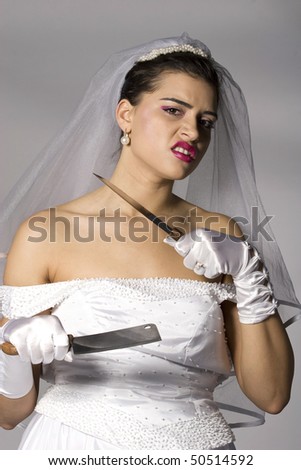 Killer bride photo series. Bridezilla holding knives. Studio shot
