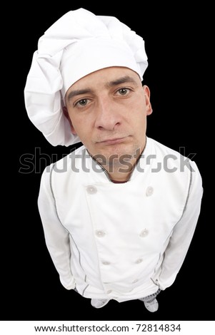 Serious young chef looking at camera. Distorted image taken in studio with fish eye lens. Isolated on pure black background.