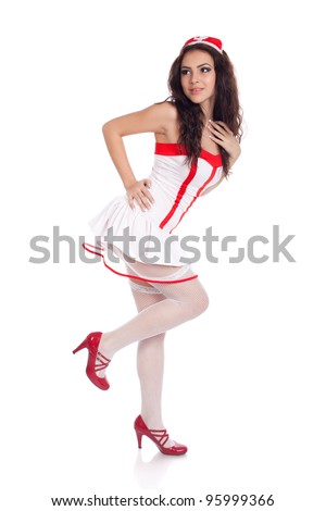 Full body shot of a sexy beautiful young nurse wearing red high heels shoes looking aside on isolated white background. High resolution studio image with copy space for text.